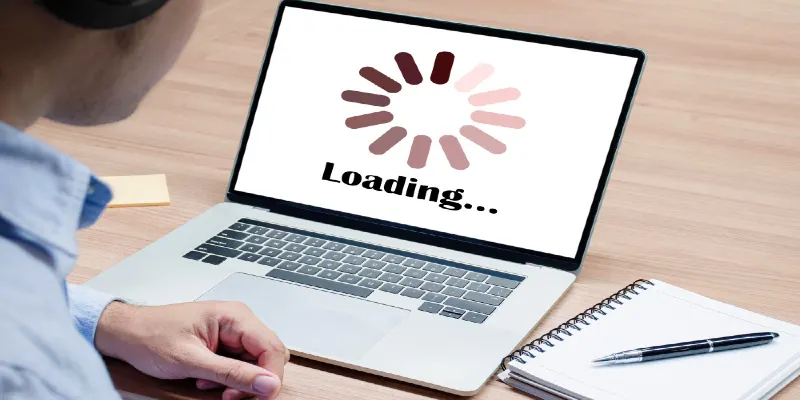 Businessman with headphone looking icon loading on display laptop